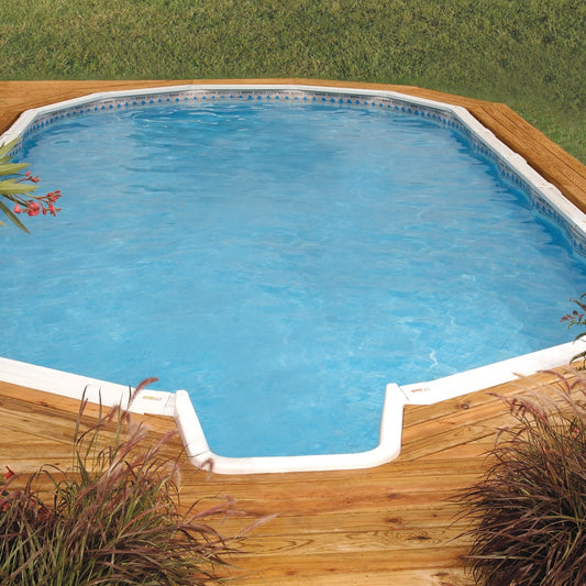 A 16' x 24' oval H.I.I. Embassy Silver Interlude 8" Premium Resin Frame Salt Friendly Semi In-Ground Pool (52") with In-Step Package, featuring clear blue water, wooden decking, green grass, and ornamental plants.