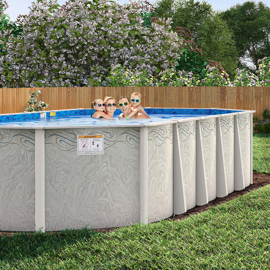 Four people wearing sunglasses relax in an H.I.I. Embassy 12' x 20' Silver Interlude 8" Resin Frame Oval Pool & Bundle, set up in a grassy backyard with a wooden fence, trees, and flowering bushes in the background.